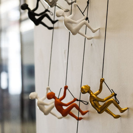 Set of Five Black Gold Orange Silver And White Resin Climbing Man Hanging Dimensional Sculpture HomeRoots